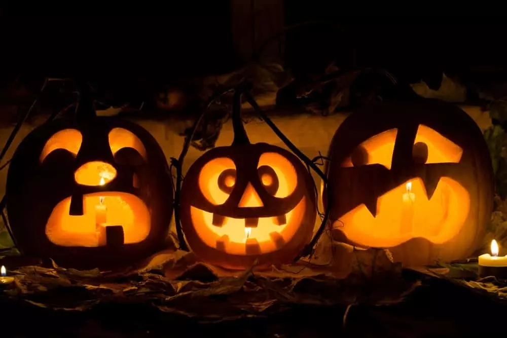 Carved pumpkins lit up at night
