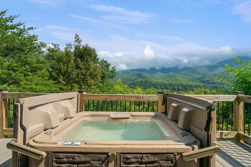 hot tub with mountain view at Three Little Bears Lodge
