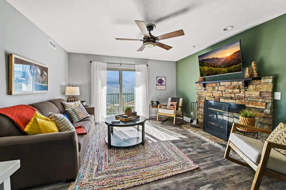 1st Living Room View w/ Green Accent Wall, Wood-burning Fireplace & Private Patio Entrance