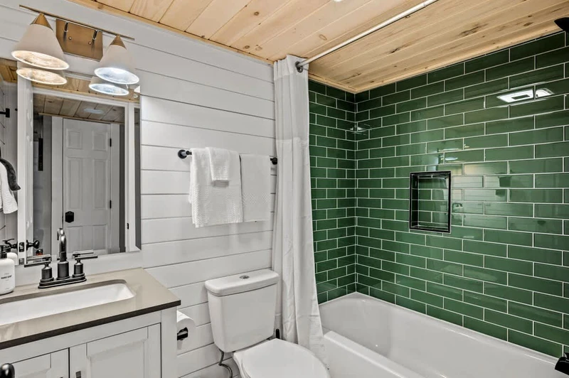 First bathroom, complete with a beautifully green-tiled shower