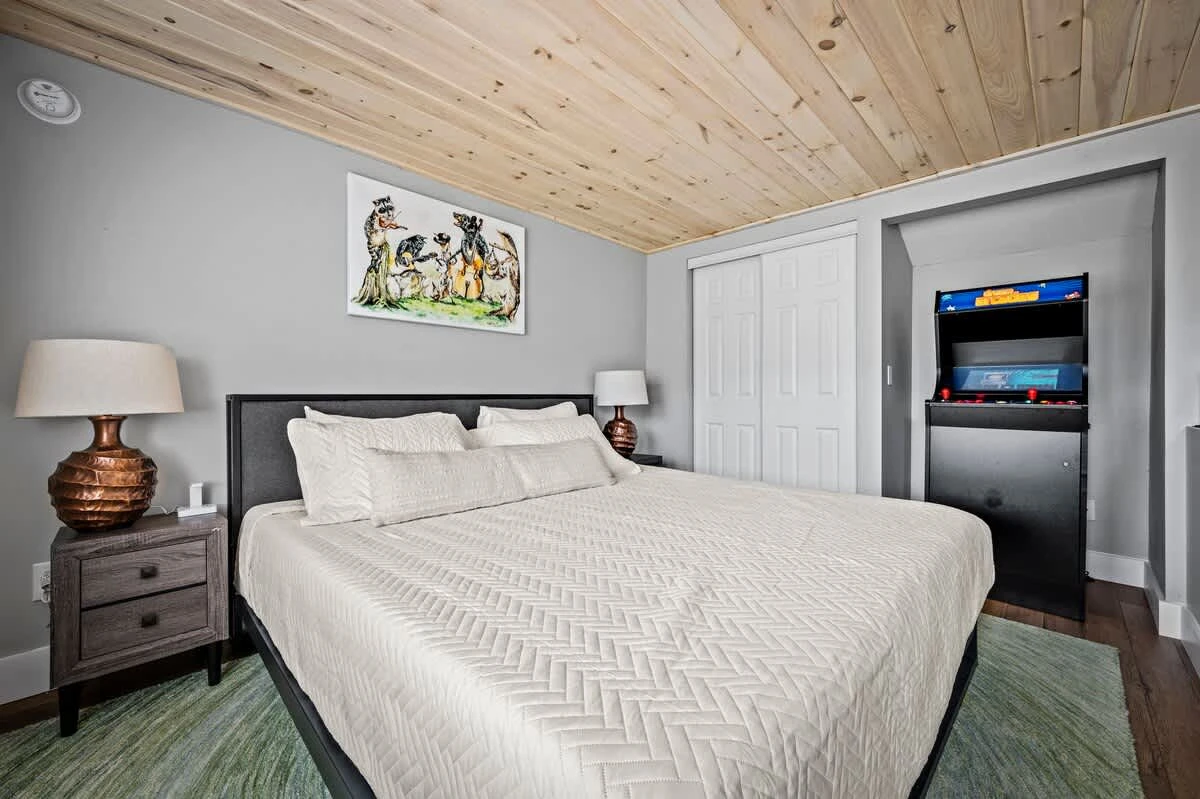 Loft bedroom which features nostalgic arcade