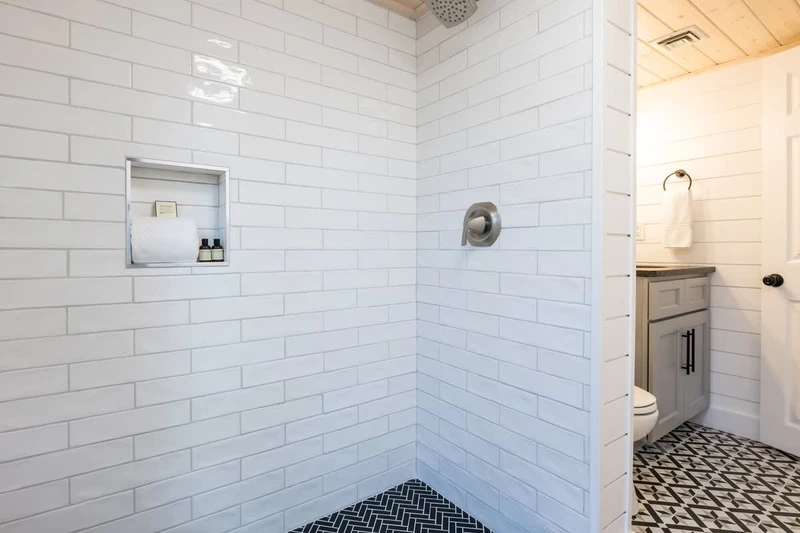 2nd View of Bathroom w/ White Tiled Shower
