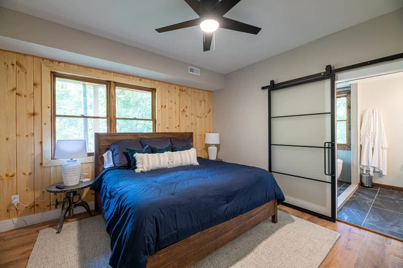 The primary bedroom connects to a large, luxe bathroom.