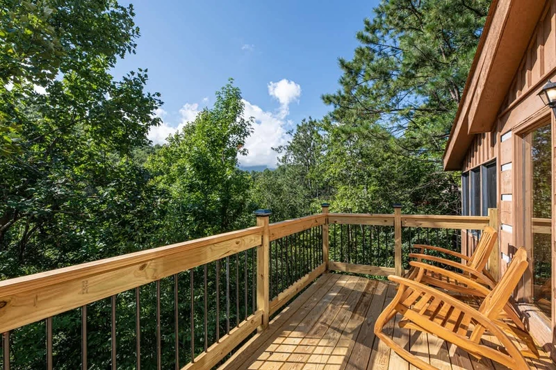 Deck features patio furniture on the right of living area entrance.