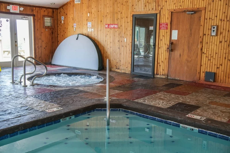 The indoor pool area includes a hot tub, steam room, and sauna.