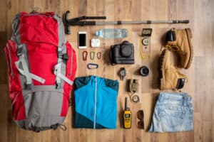 hiking gear laid out on a wooden floor