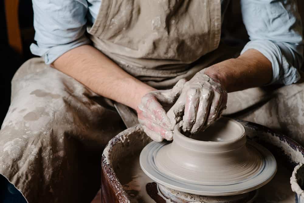 man making pottery on wheel