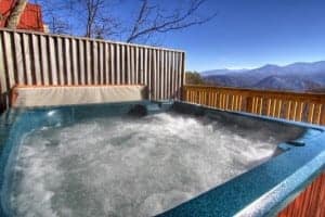 hot tub on the deck of a cabin