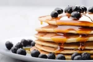 Blueberry pancakes with fresh blueberries and syrup