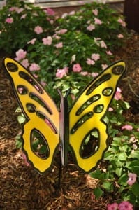 Yellow butterfly decor in a flower bed at Dollywood