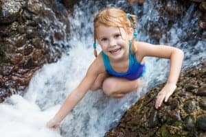 kid playing on Smoky Mountain hiking trail with waterfall
