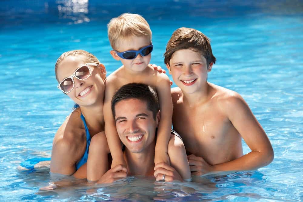 Family swimming while staying in a Pigeon Forge cabin with swimming pool access
