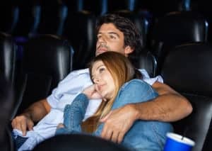 couple watching a movie in a romantic Gatlinburg cabin with movie theater room