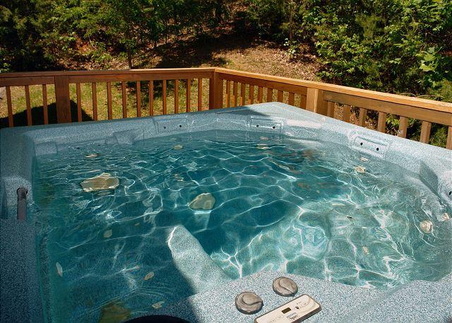 Crystal clear water in hot tub on the deck of a secluded Smoky Mountain rental cabin