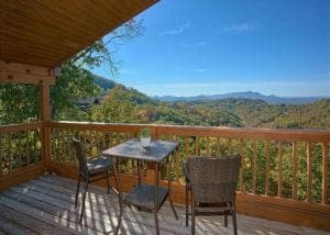 Table and two chairs on deck of cabins with Mountain Views in Great Smoky Mountains