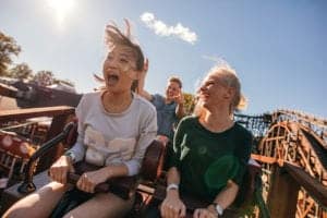 Two young girls laughing while riding wooden roller coaster at Dollywood in Pigeon Forge, Tn