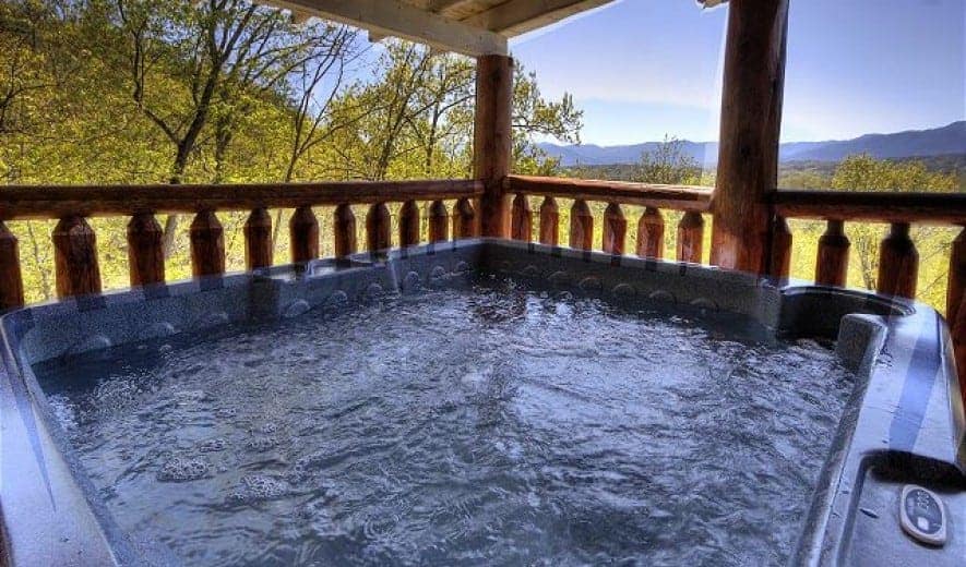 hot tub on a deck with a mountain view